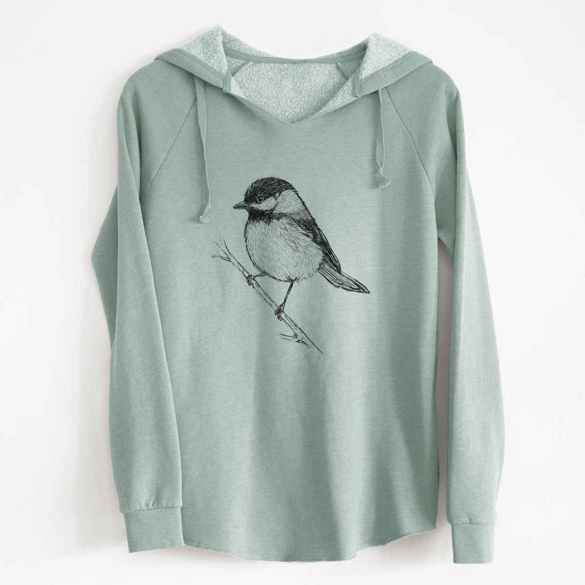 Sage green women's Cali Wave hooded sweatshirt laid flat, printed with a detailed black ink sketch of a black-capped chickadee perched on a branch.