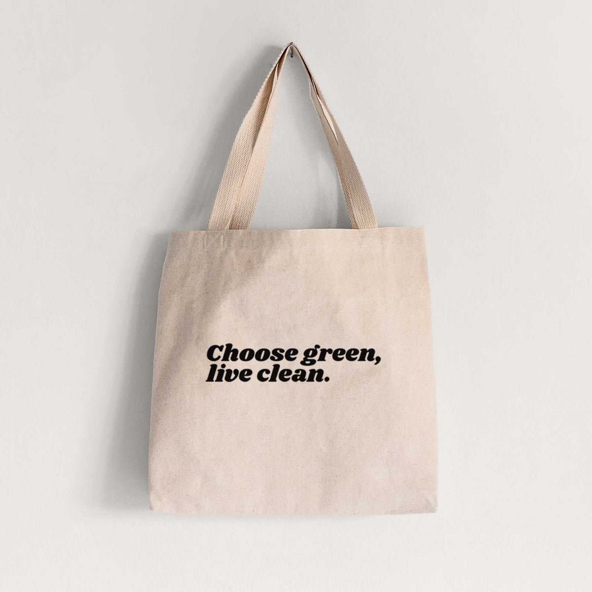 Natural canvas tote bag printed with small black script words reading Choose Green, Live Clean on the upper chest.