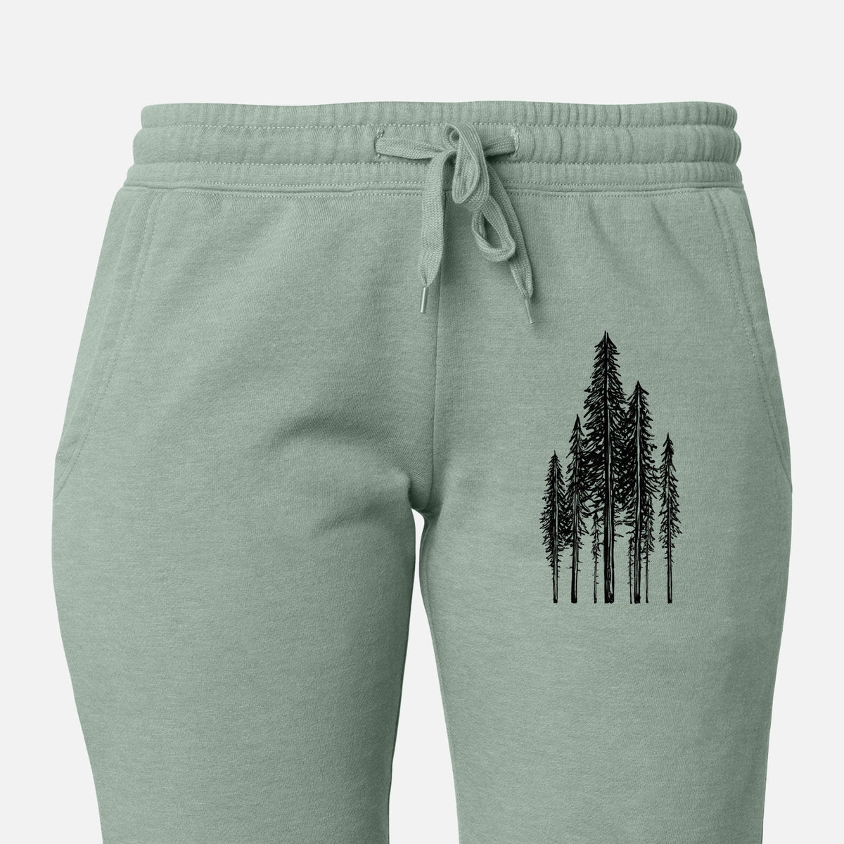 Front of sage green Cali Wave sweatpants, printed with a black ink illustration of a stand of tall coastal redwood trees with slender trunks and layered branches on the leg.