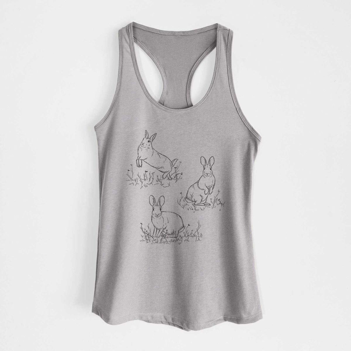Heather grey women's racerback tank top laid flat, printed with a black ink illustration of three cottontail rabbits among grass and flowers.