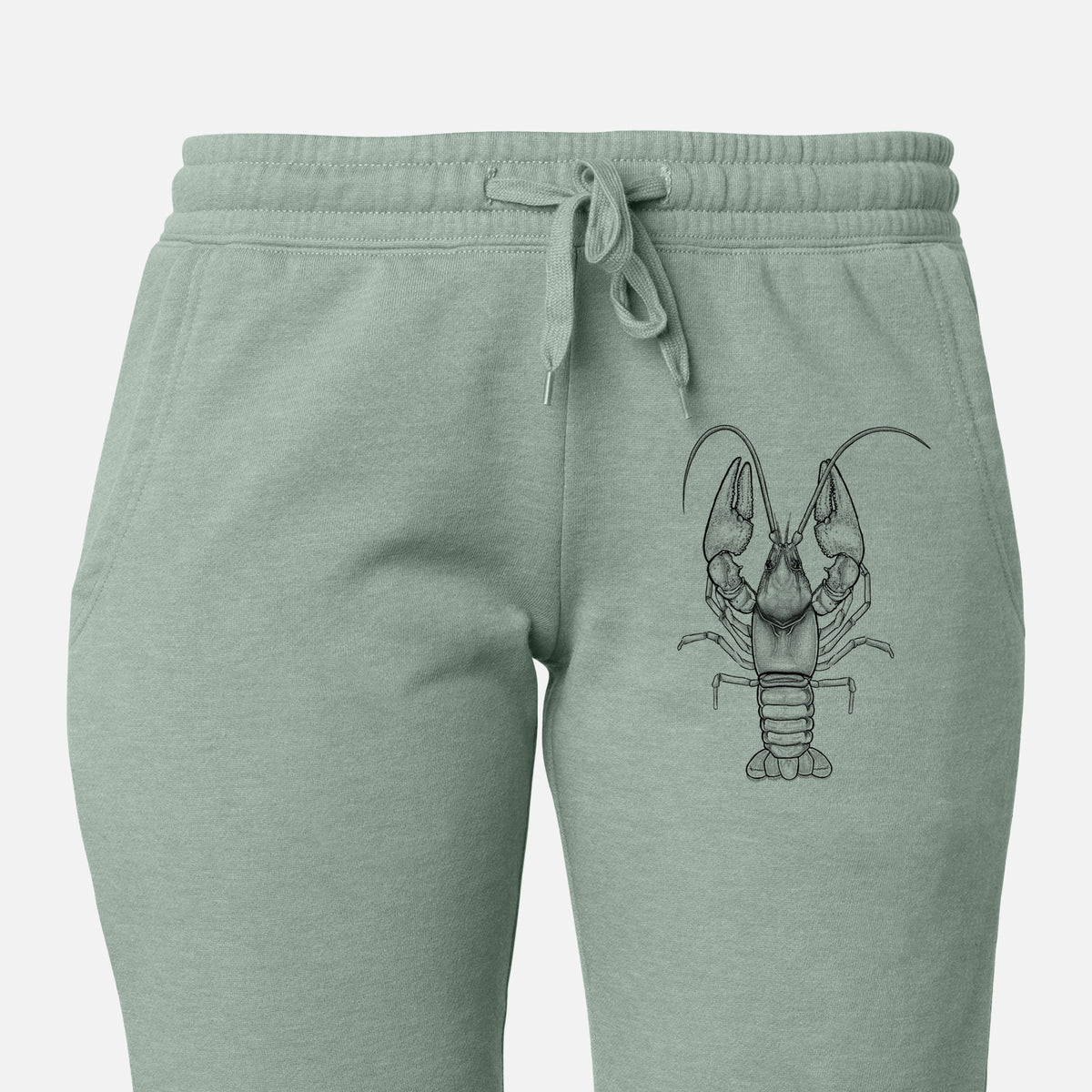 Front of sage green Cali Wave sweatpants, printed with a detailed black ink illustration of a crayfish with its claws raised, seen from above on the leg.