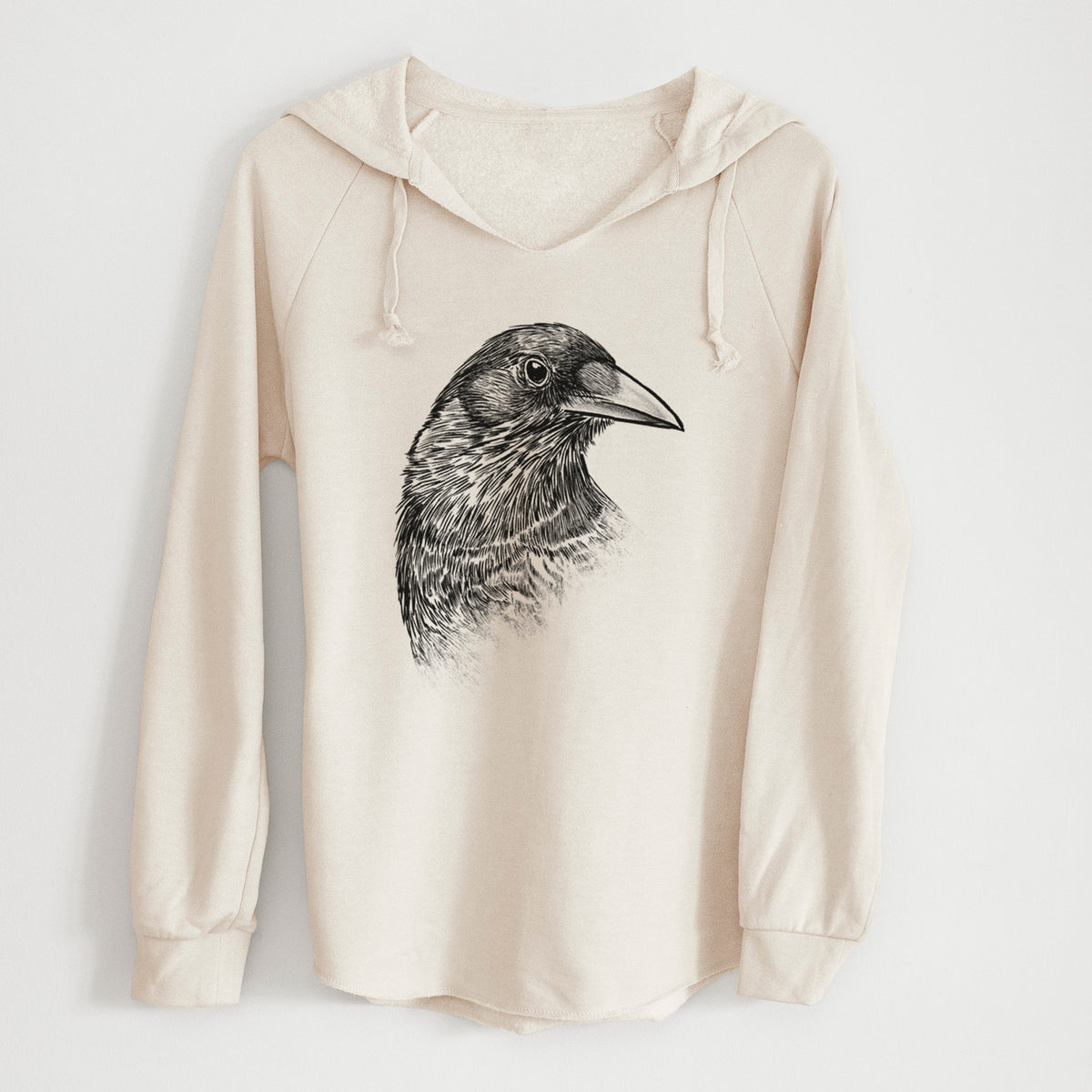Bone cream women's Cali Wave hooded sweatshirt laid flat, printed with a detailed black ink portrait of a crow's head in profile.