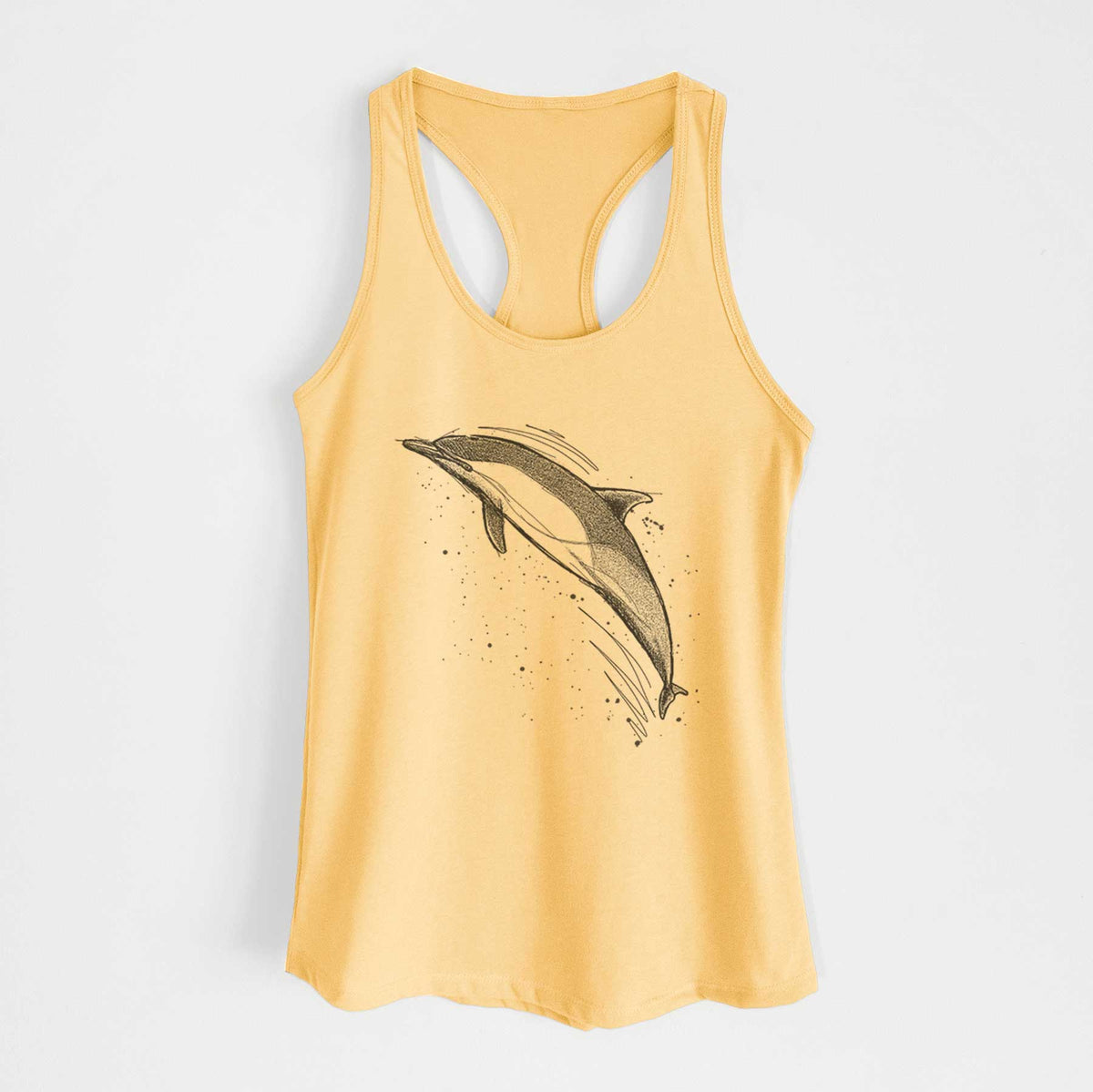 Banana cream women's racerback tank top laid flat, printed with a black ink illustration of a common dolphin leaping, with ink splatters.