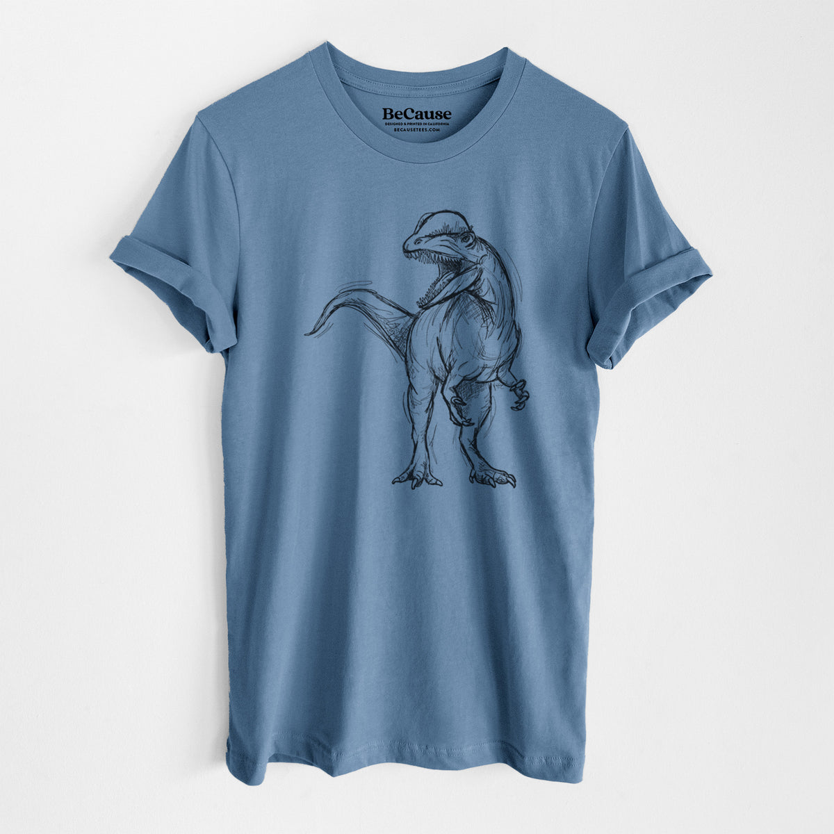 Steel blue lightweight cotton t-shirt laid flat, printed with a black ink illustration of a Dilophosaurus with its neck frill, walking.