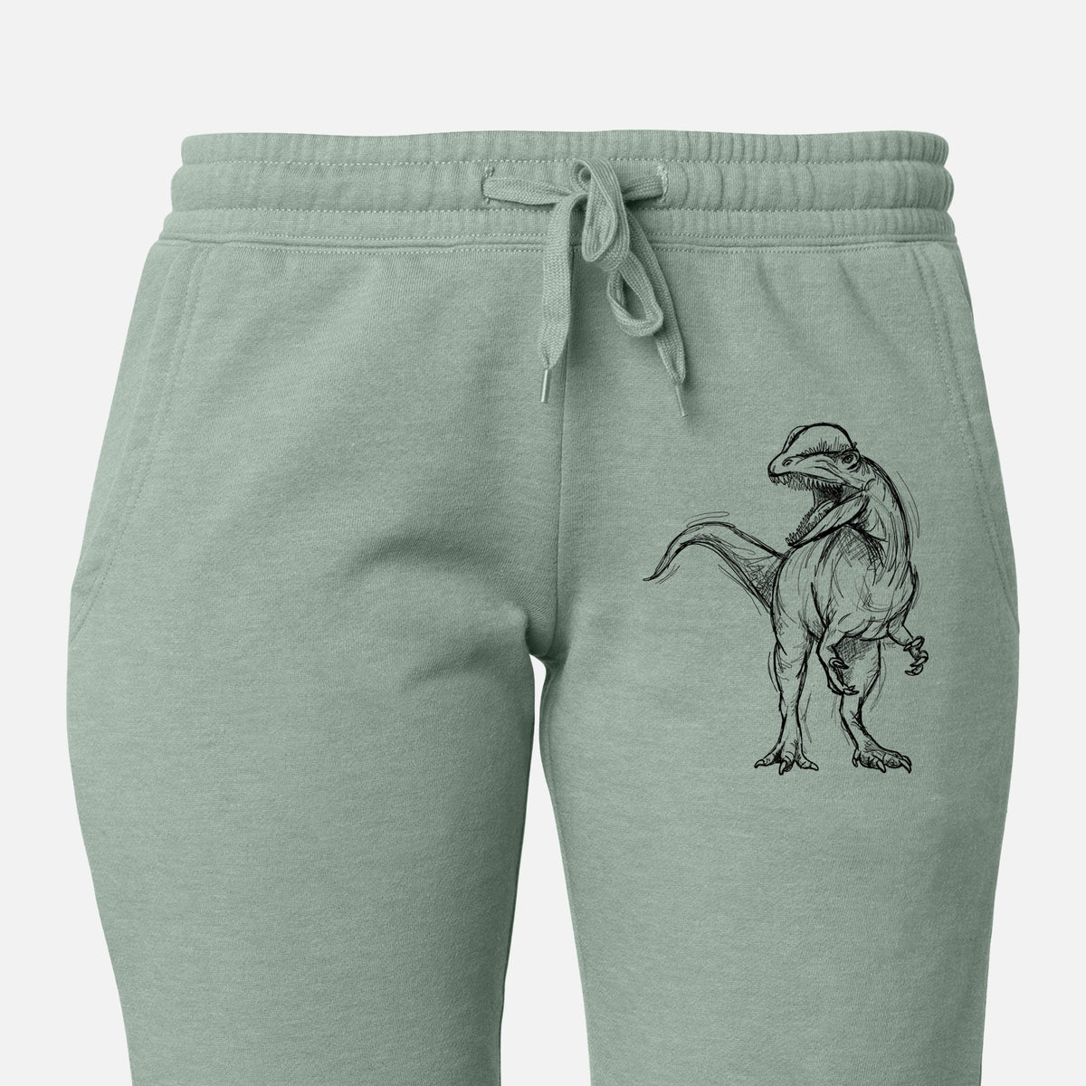 Front of sage green Cali Wave sweatpants, printed with a black ink illustration of a Dilophosaurus with its neck frill, walking on the leg.