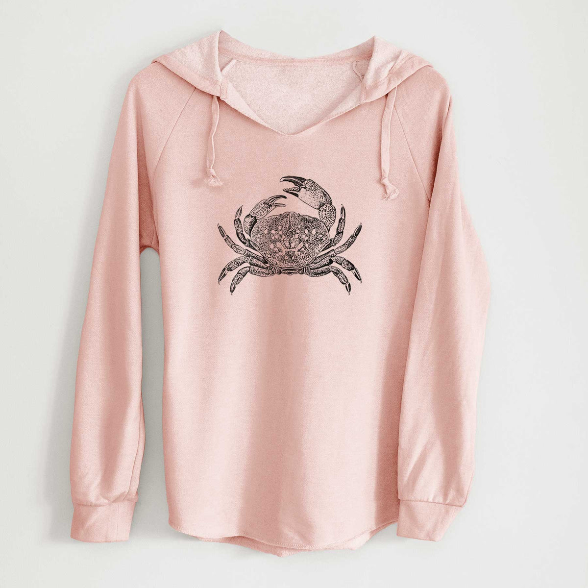 Blush pink women's Cali Wave hooded sweatshirt laid flat, printed with a detailed black ink illustration of a Dungeness crab with claws raised, seen from above.