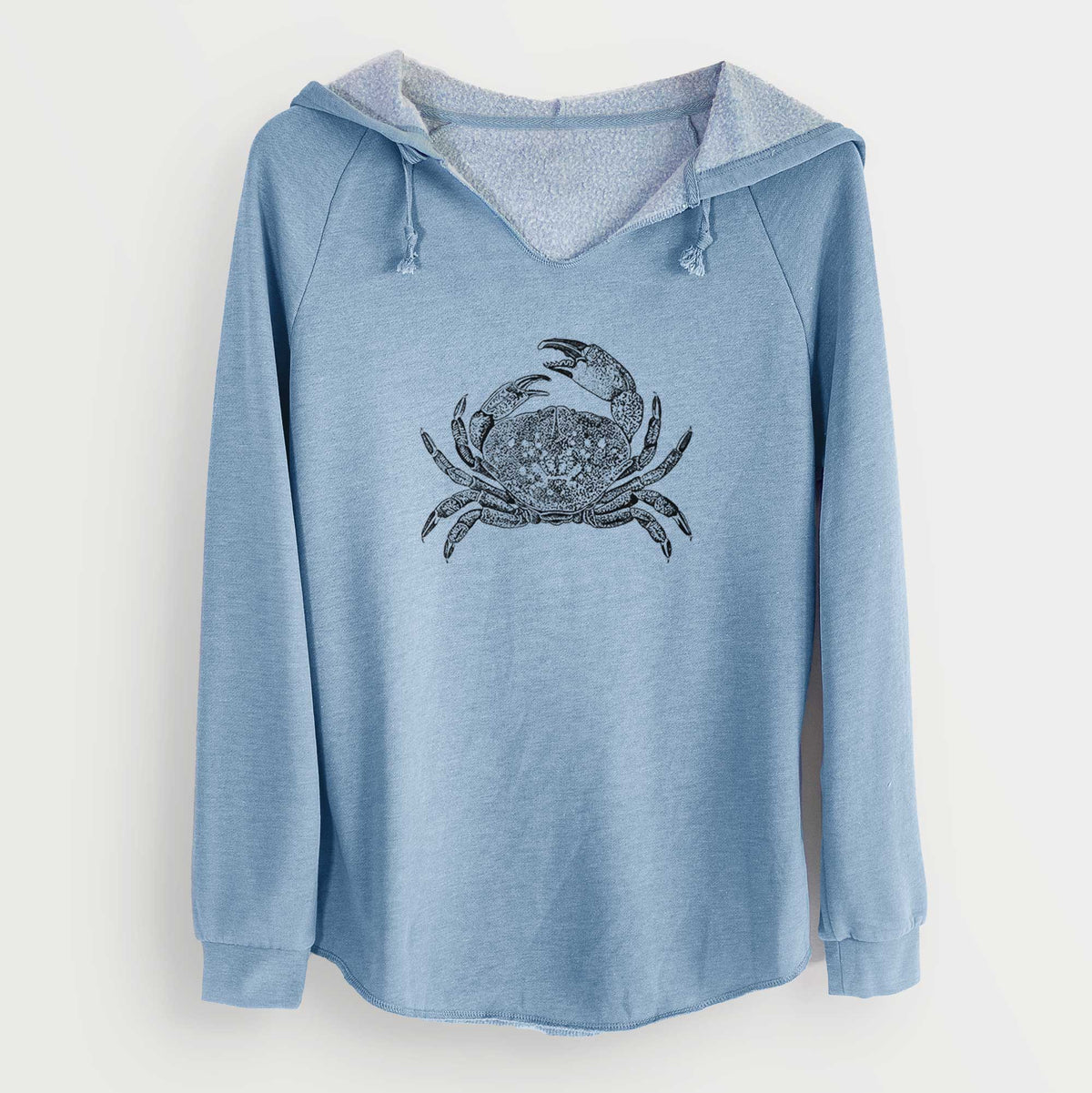 Misty blue women's Cali Wave hooded sweatshirt laid flat, printed with a detailed black ink illustration of a Dungeness crab with claws raised, seen from above.