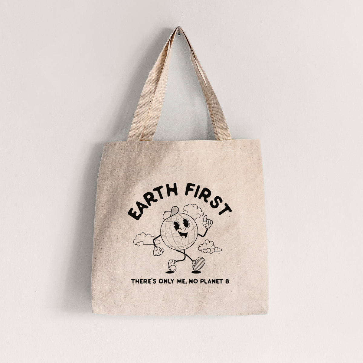 Natural canvas tote bag printed with a cheerful cartoon Earth running, with the words Earth First and There's Only Me, No Planet B.