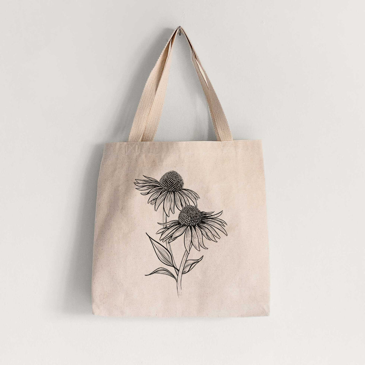 Natural canvas tote bag printed with a black ink line drawing of two coneflowers on tall stems.