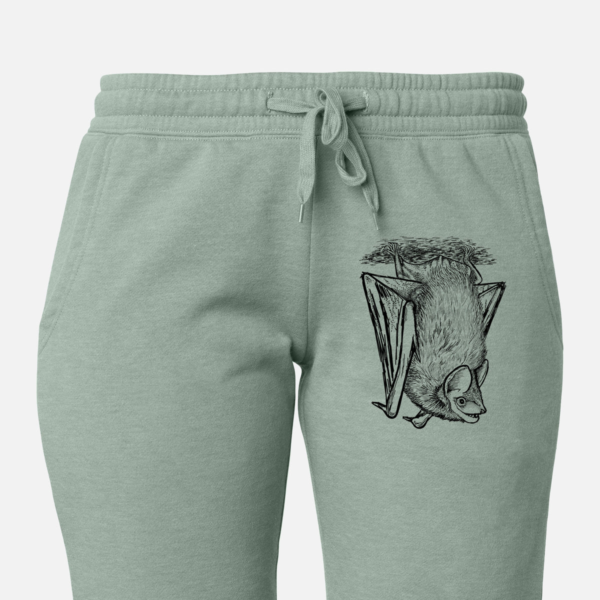 Front of sage green Cali Wave sweatpants, printed with a detailed black ink illustration of a big brown bat hanging upside down on the leg.