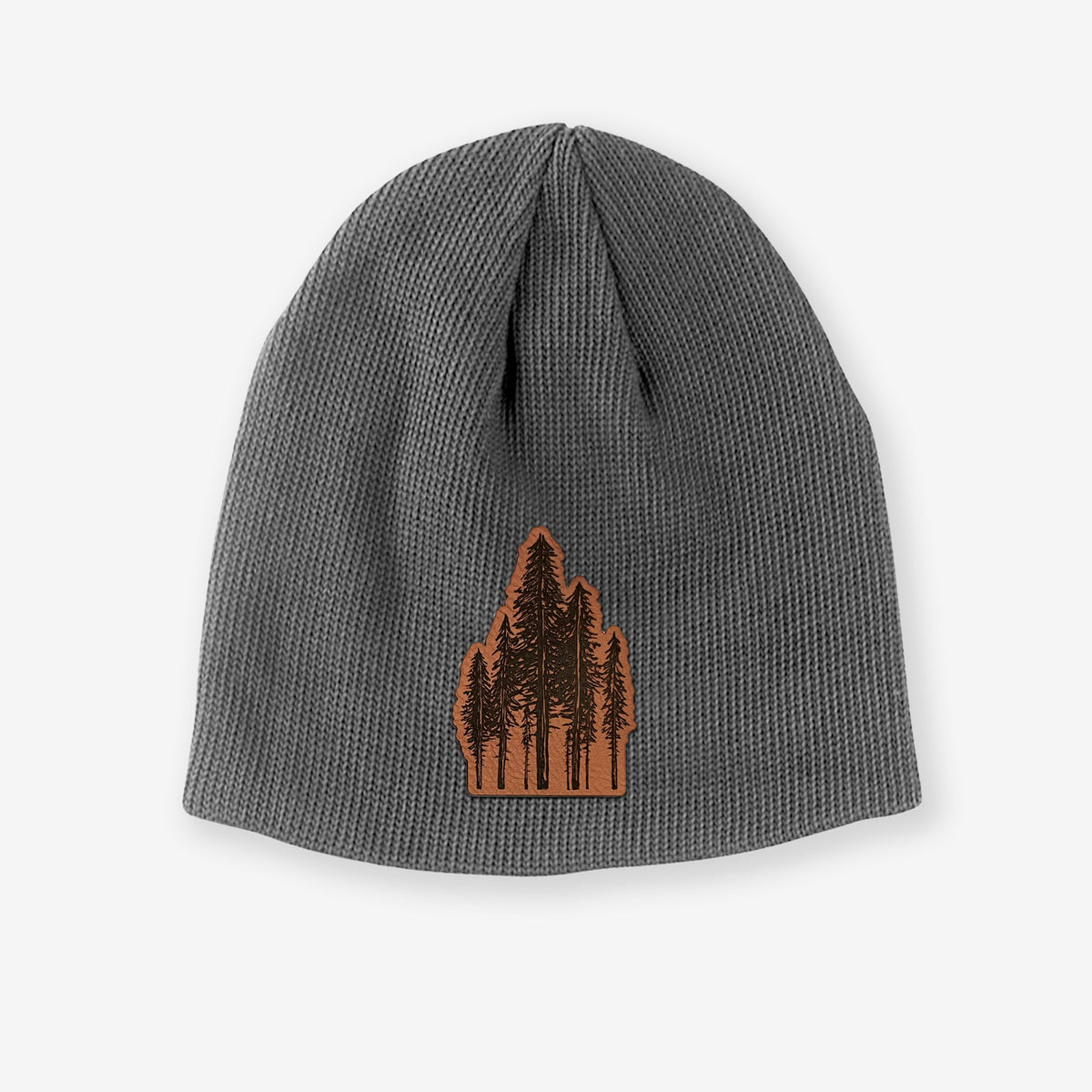 Grey cotton beanie with a black ink illustration of a cluster of evergreen trees of varying heights on the front.
