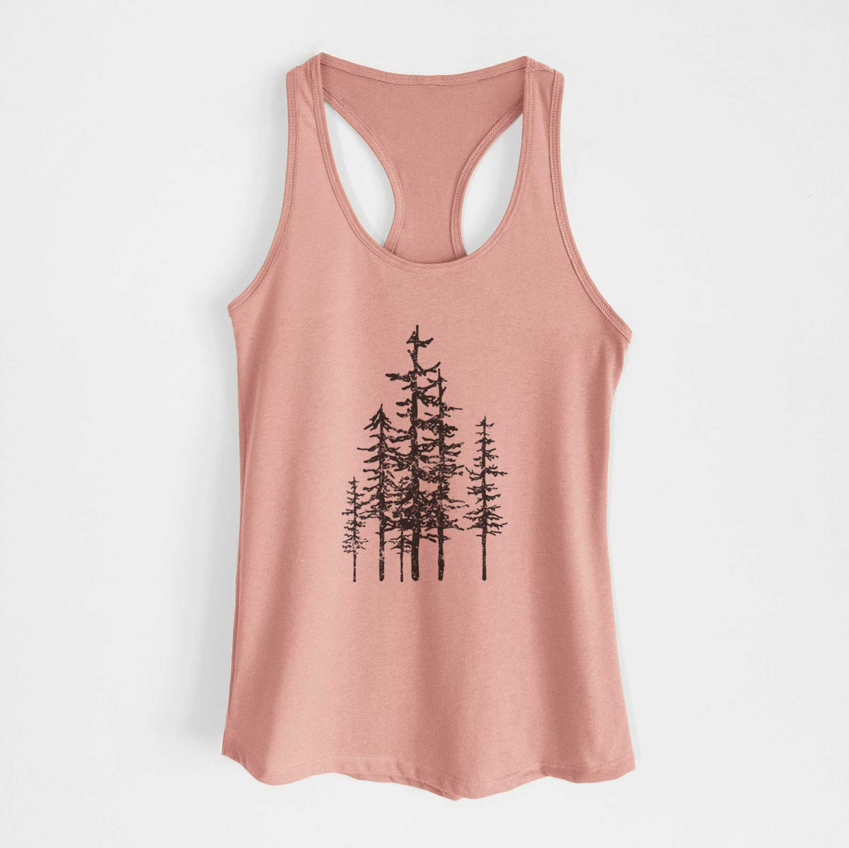 Desert pink women's racerback tank top laid flat, printed with a black ink illustration of a cluster of evergreen trees of varying heights.