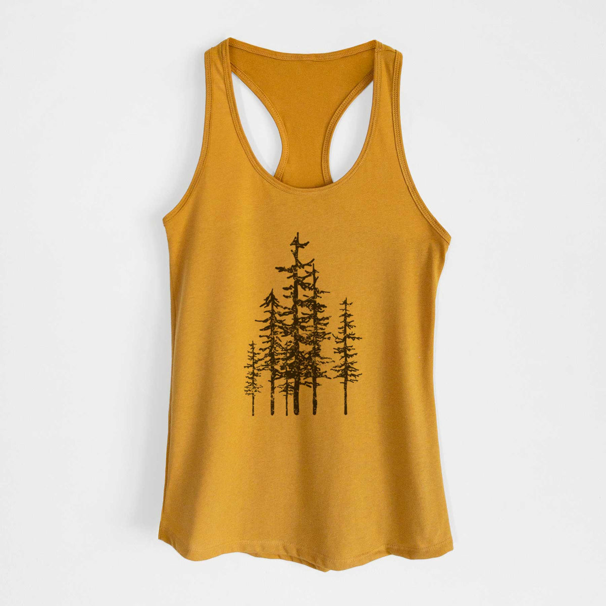 Gold women's racerback tank top laid flat, printed with a black ink illustration of a cluster of evergreen trees of varying heights.