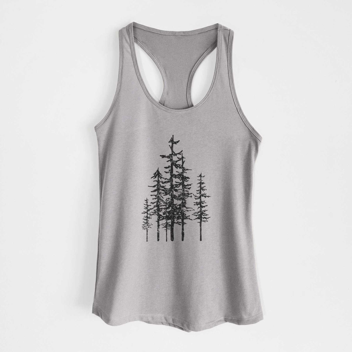 Heather grey women's racerback tank top laid flat, printed with a black ink illustration of a cluster of evergreen trees of varying heights.