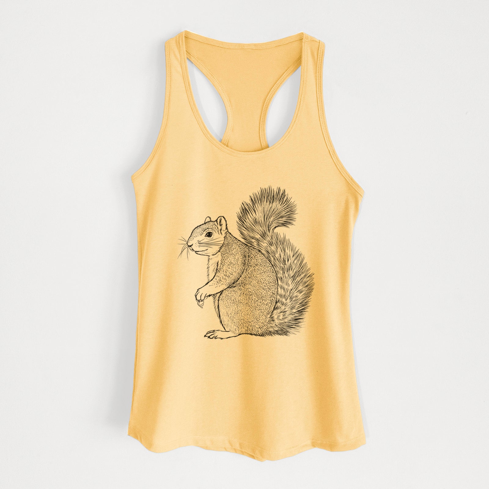 Banana cream women's racerback tank top laid flat, printed with a detailed black ink illustration of a fox squirrel sitting with a bushy tail.