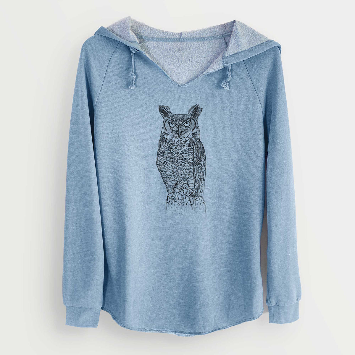Misty blue women's Cali Wave hooded sweatshirt laid flat, printed with a detailed black ink illustration of a great horned owl standing upright with its ear tufts raised.