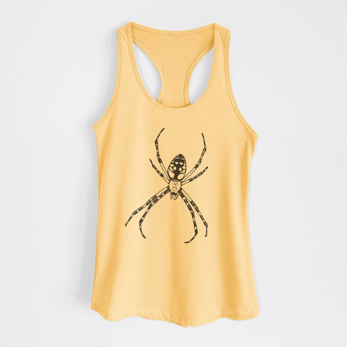 Banana cream women's racerback tank top laid flat, printed with a detailed black ink illustration of a garden spider with long striped legs.