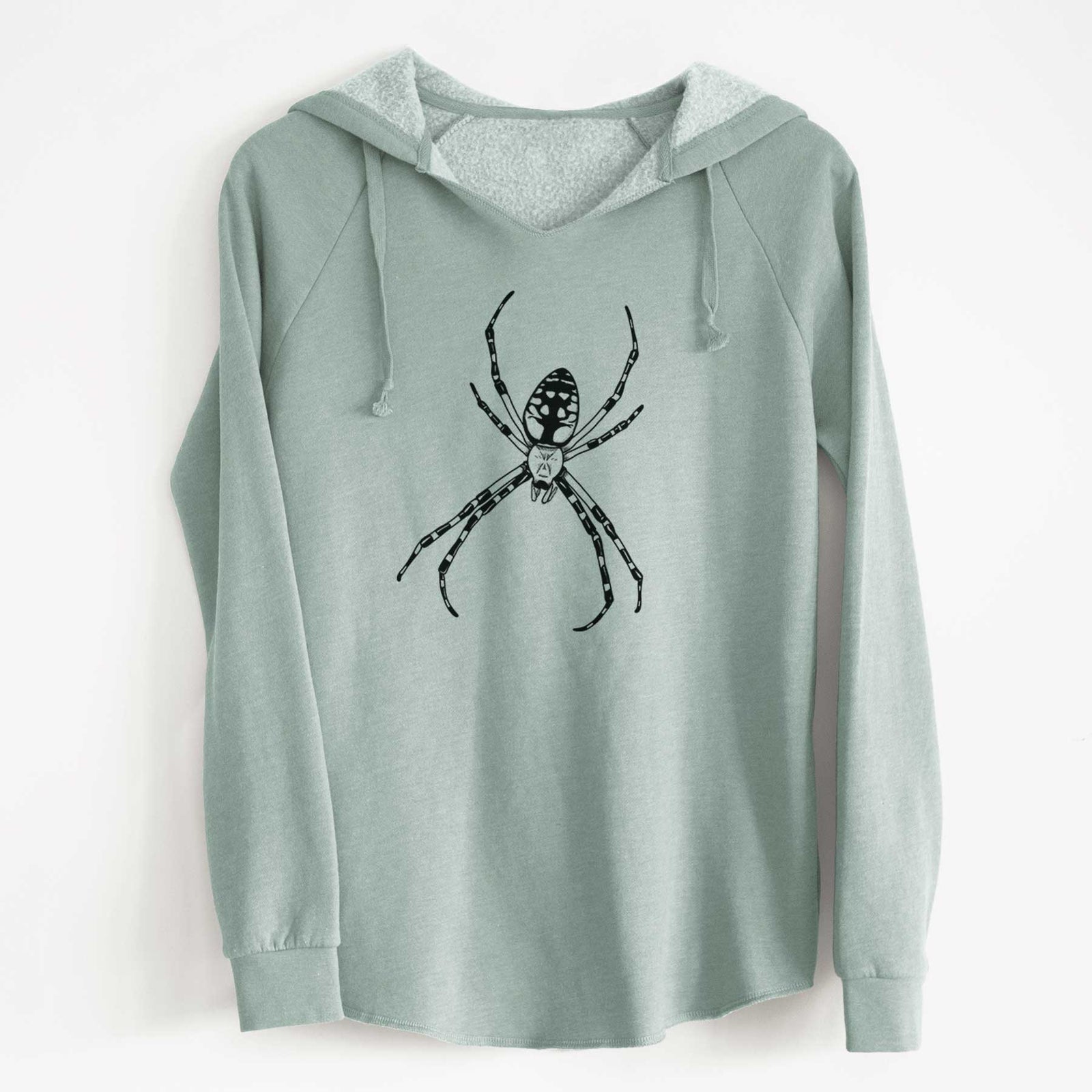 Sage green women's Cali Wave hooded sweatshirt laid flat, printed with a detailed black ink illustration of a garden spider with long striped legs.