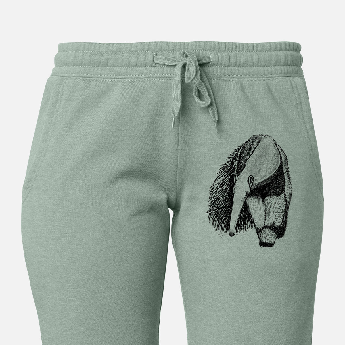 Front of sage green Cali Wave sweatpants, printed with a detailed black ink illustration of a giant anteater with its long snout and bushy tail on the leg.