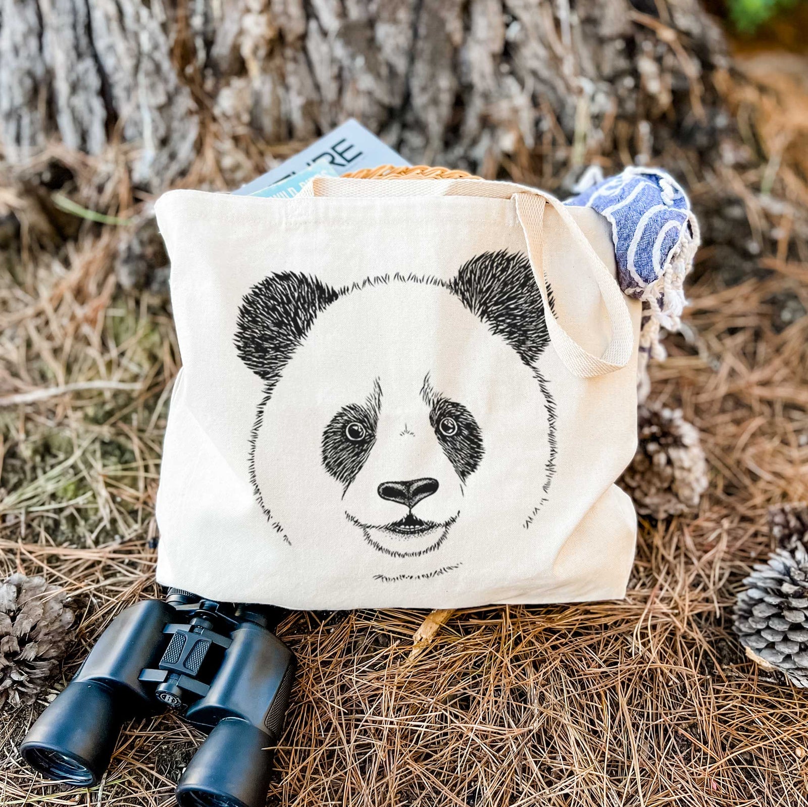 Natural canvas tote bag printed with a black ink portrait of a smiling giant panda's face.