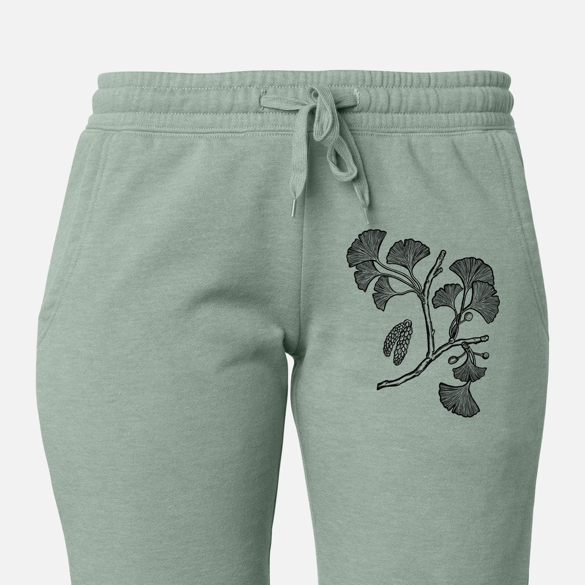 Front of sage green Cali Wave sweatpants, printed with a black ink illustration of a ginkgo branch with fan-shaped leaves on the leg.
