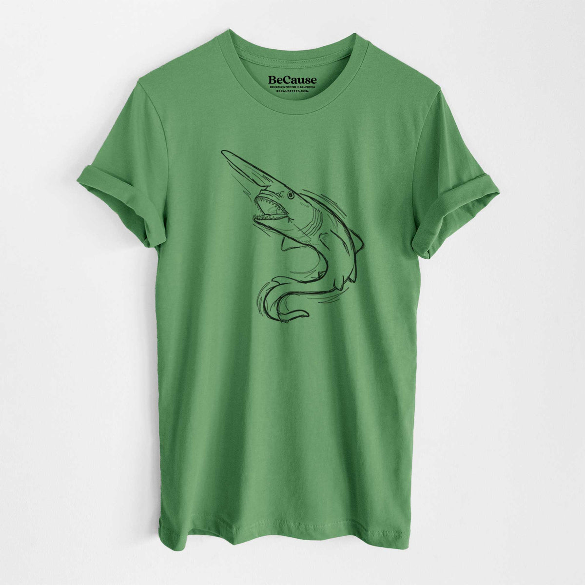 Leaf green lightweight cotton t-shirt laid flat, printed with a black ink illustration of a goblin shark with its long snout, swimming in a curve.