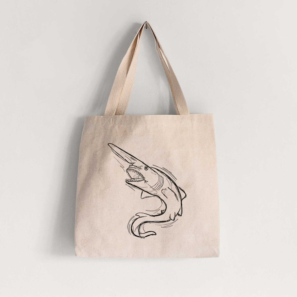 Natural canvas tote bag printed with a black ink illustration of a goblin shark with its long snout, swimming in a curve.