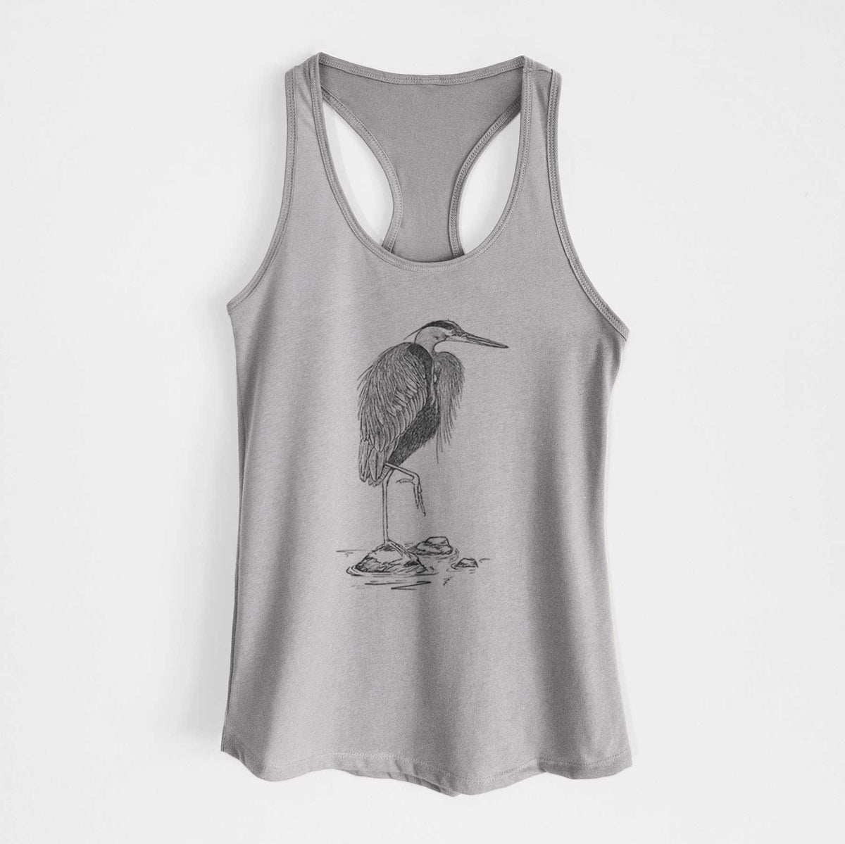 Heather grey women's racerback tank top laid flat, printed with a detailed black ink illustration of a great blue heron standing on rocks.