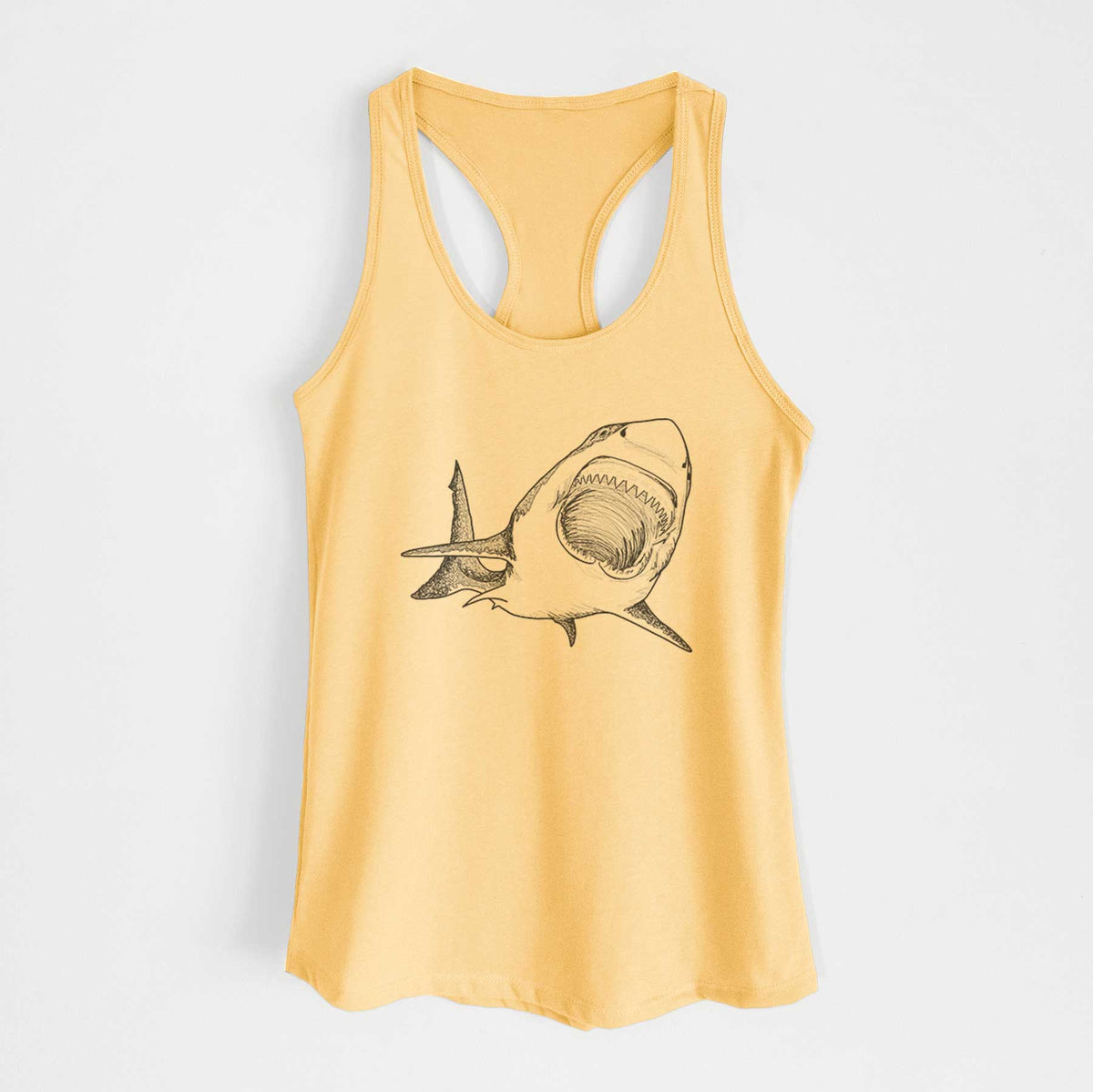 Banana cream women's racerback tank top laid flat, printed with a black ink illustration of a great white shark swimming toward the viewer with its mouth open.