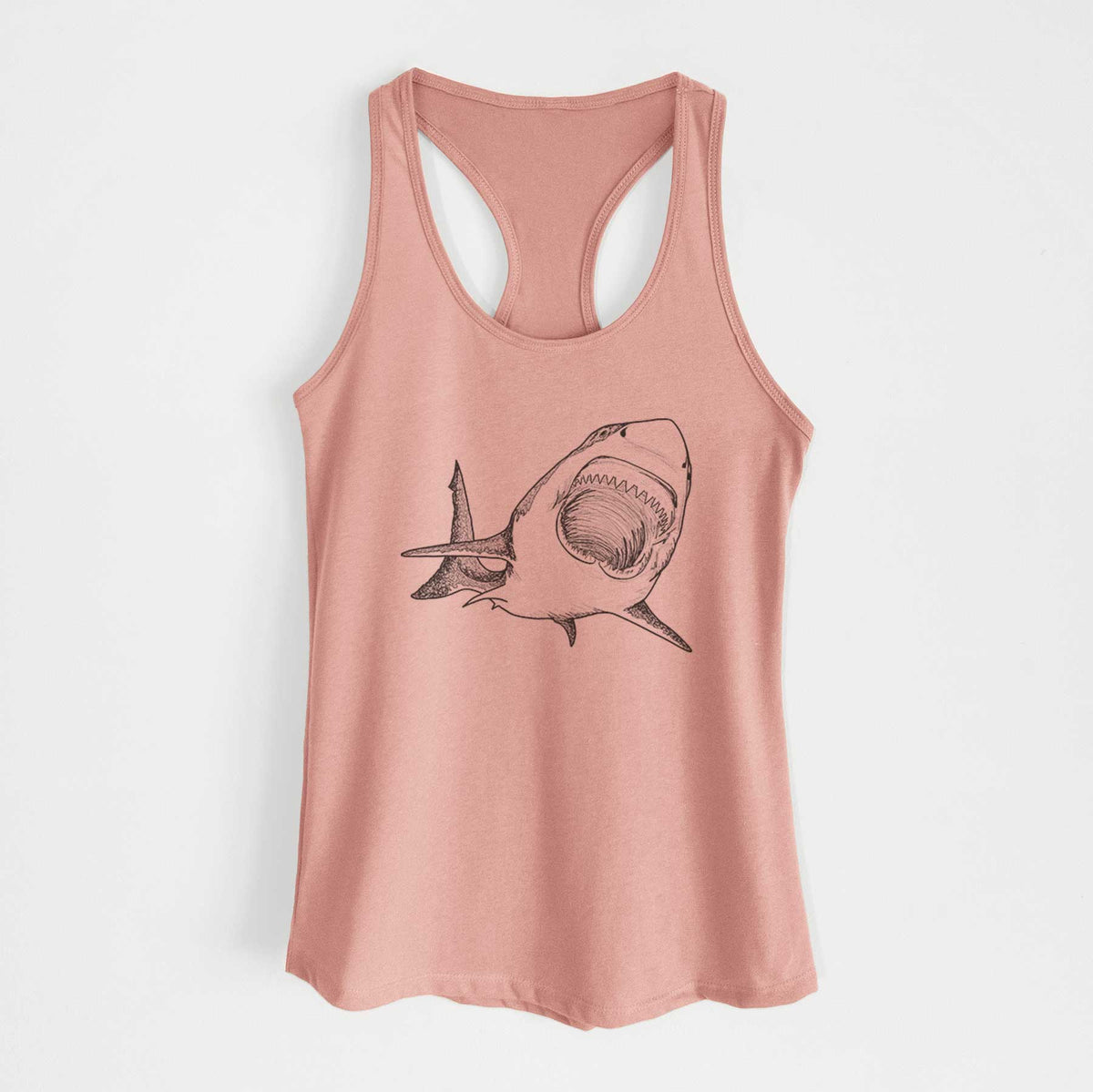 Desert pink women's racerback tank top laid flat, printed with a black ink illustration of a great white shark swimming toward the viewer with its mouth open.