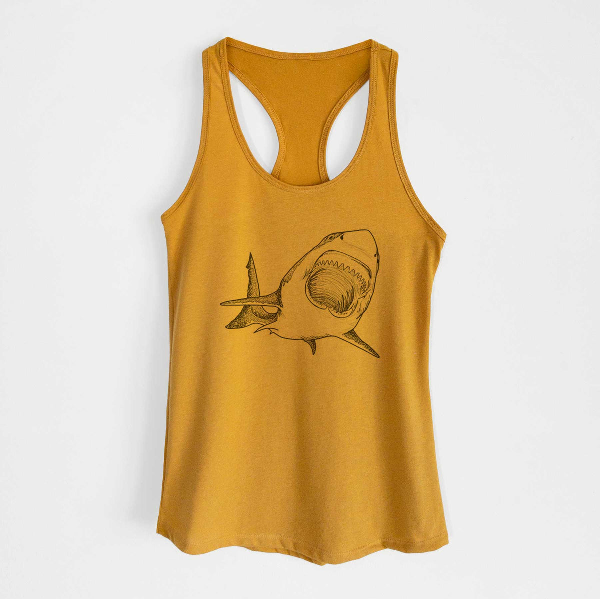 Gold women's racerback tank top laid flat, printed with a black ink illustration of a great white shark swimming toward the viewer with its mouth open.