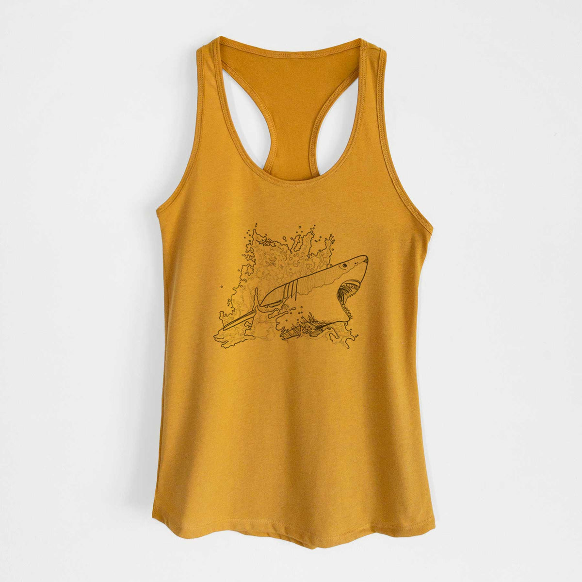 Gold women's racerback tank top laid flat, printed with a black ink illustration of a great white shark breaking through a splash of water.