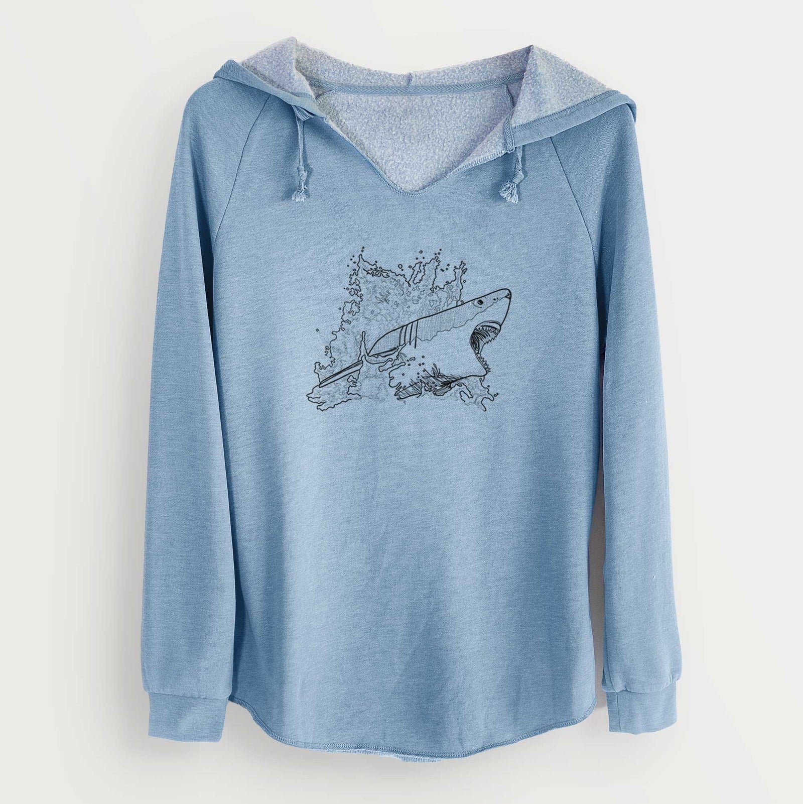 Misty blue women's Cali Wave hooded sweatshirt laid flat, printed with a black ink illustration of a great white shark breaking through a splash of water.