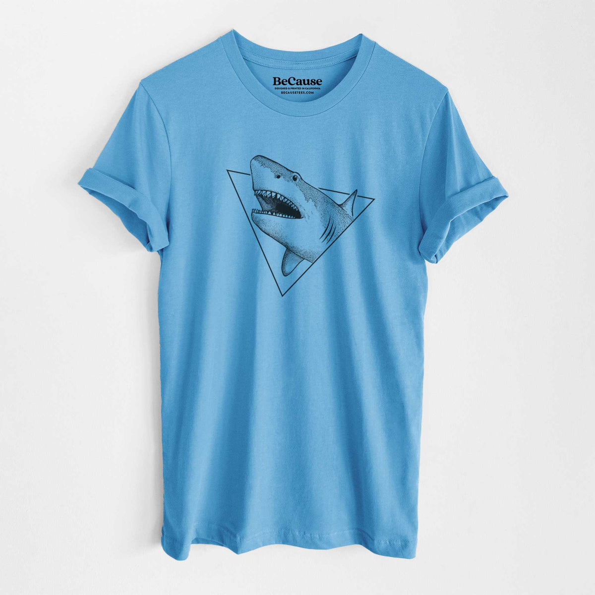 Ocean blue lightweight cotton t-shirt laid flat, printed with a black ink great white shark bursting out of a triangle outline with its mouth open.