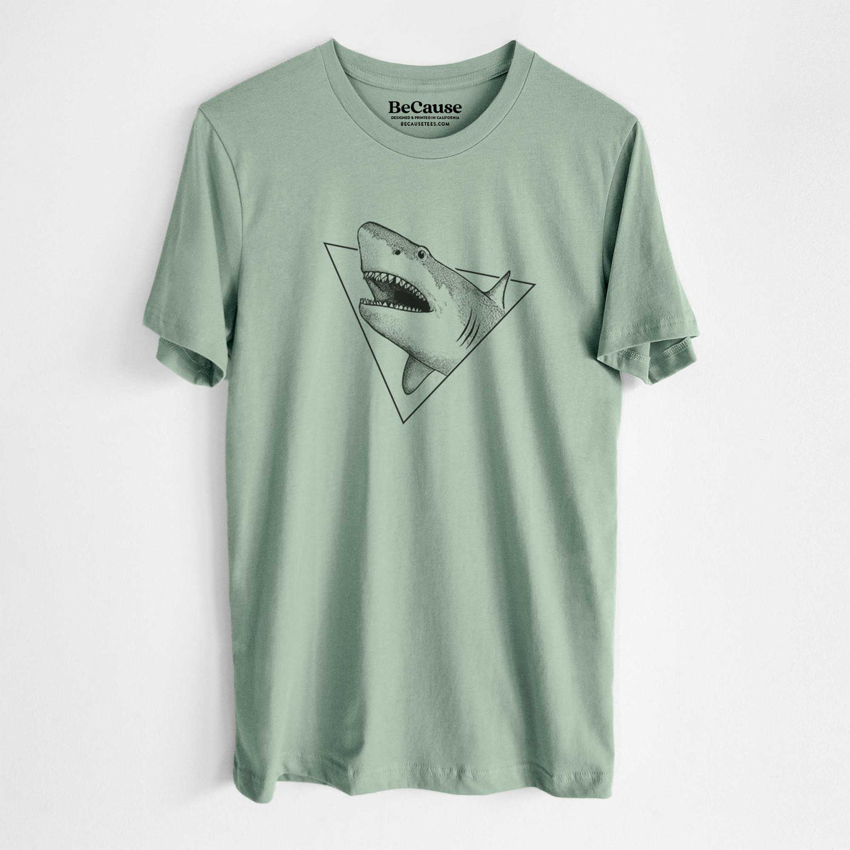 Sage green lightweight cotton t-shirt laid flat, printed with a black ink great white shark bursting out of a triangle outline with its mouth open.