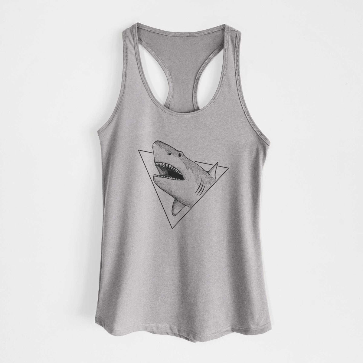 Heather grey women's racerback tank top laid flat, printed with a black ink great white shark bursting out of a triangle outline with its mouth open.