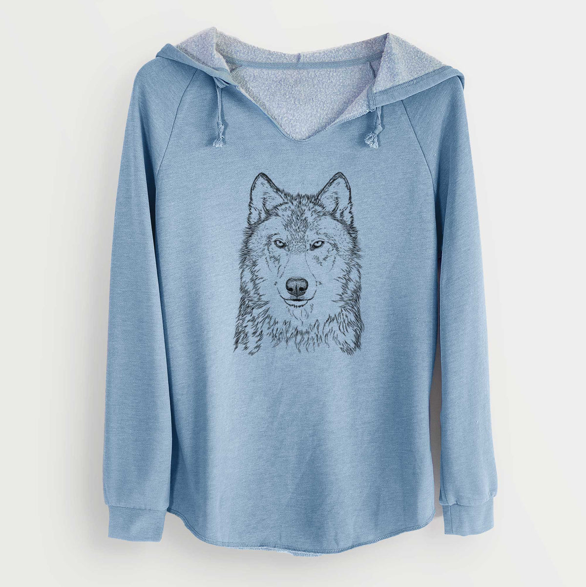 Misty blue women's Cali Wave hooded sweatshirt laid flat, printed with a detailed black ink portrait of a grey wolf facing forward.