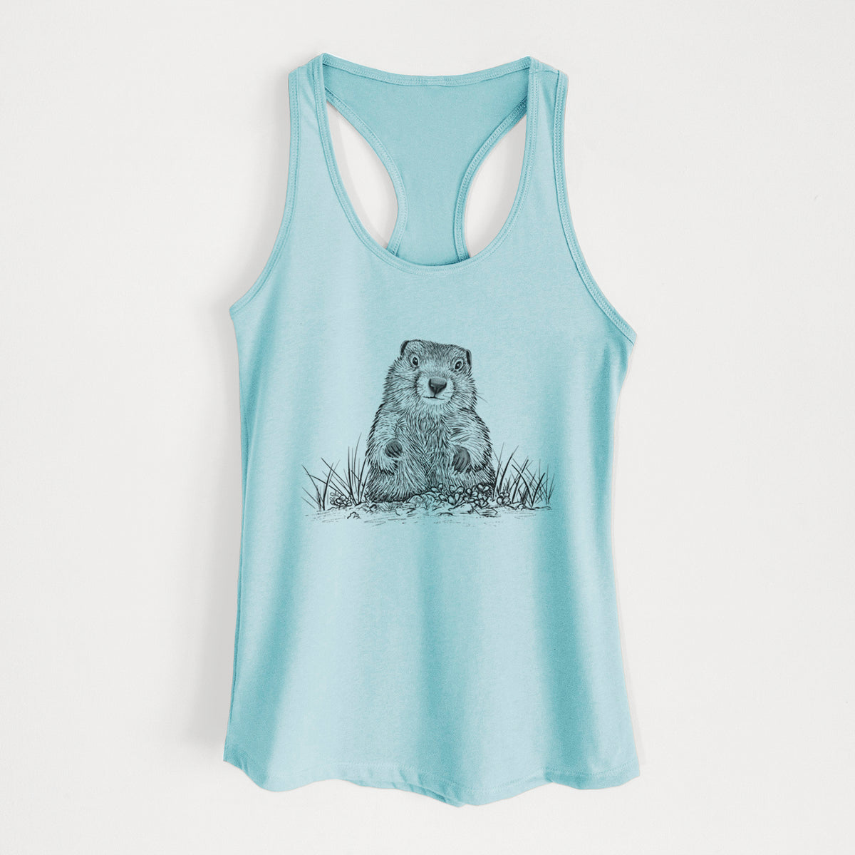 Cancun blue women's racerback tank top laid flat, printed with a black ink illustration of a groundhog peeking out of its burrow among grass.