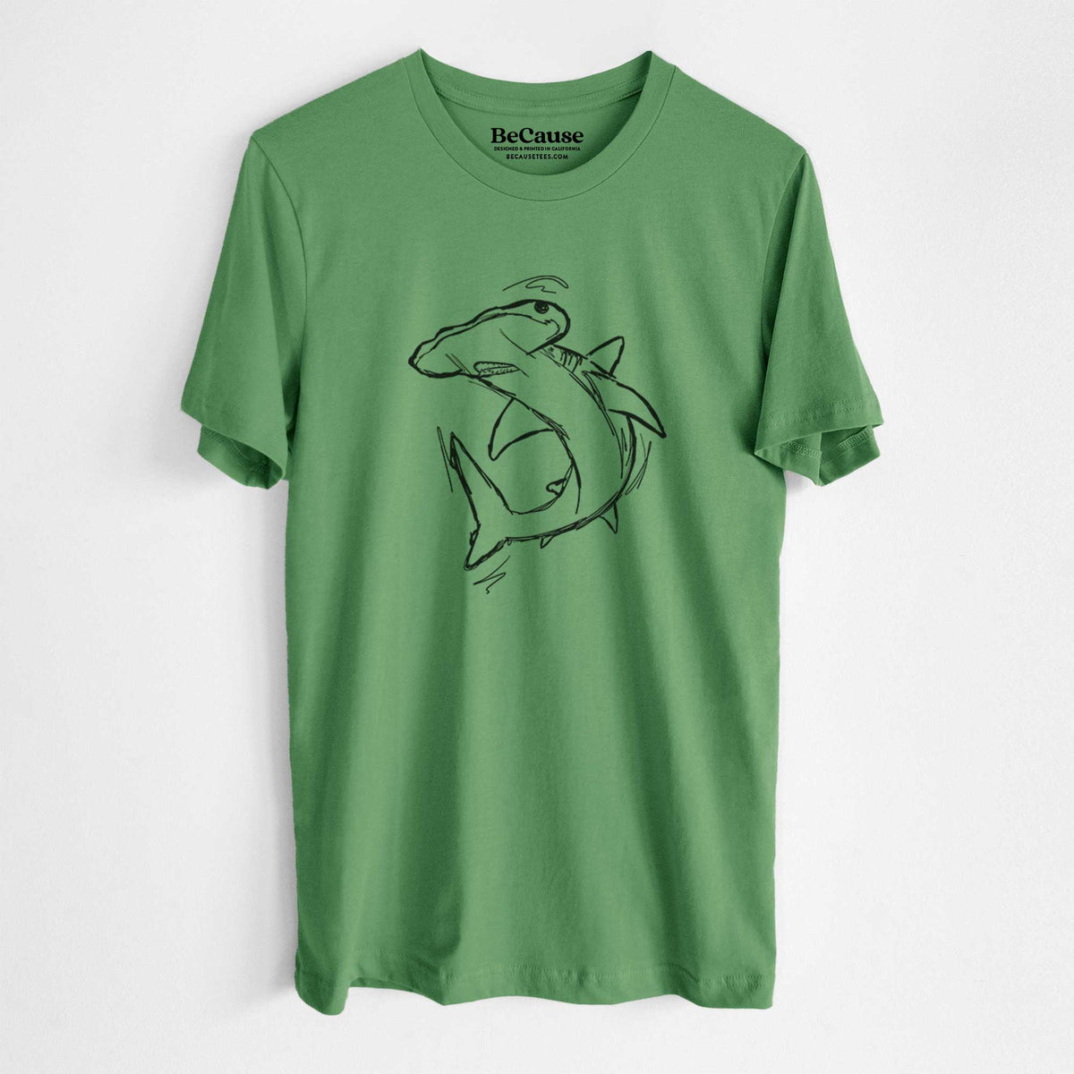Leaf green lightweight cotton t-shirt laid flat, printed with a black ink illustration of a hammerhead shark swimming in a curve.