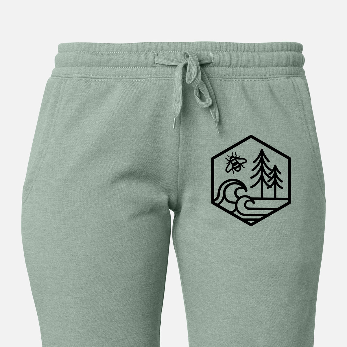 Front of sage green Cali Wave sweatpants, printed with a black line art hexagon holding a bee, ocean waves and pine trees on the leg.
