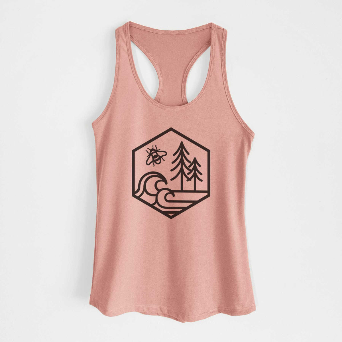 Desert pink women's racerback tank top laid flat, printed with a black line art hexagon holding a bee, ocean waves and pine trees.