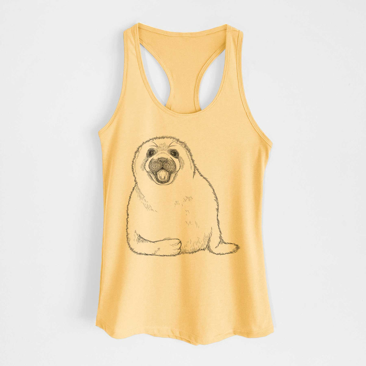 Banana cream women's racerback tank top laid flat, printed with a black ink illustration of a smiling harp seal pup lying down.