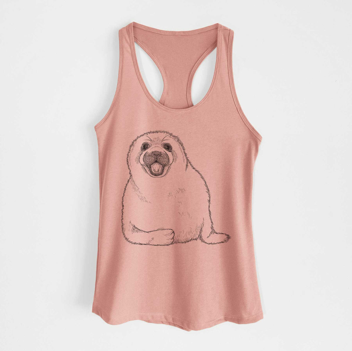Desert pink women's racerback tank top laid flat, printed with a black ink illustration of a smiling harp seal pup lying down.