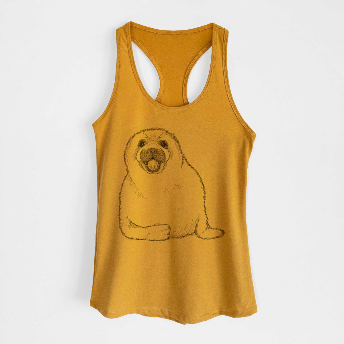 Gold women's racerback tank top laid flat, printed with a black ink illustration of a smiling harp seal pup lying down.