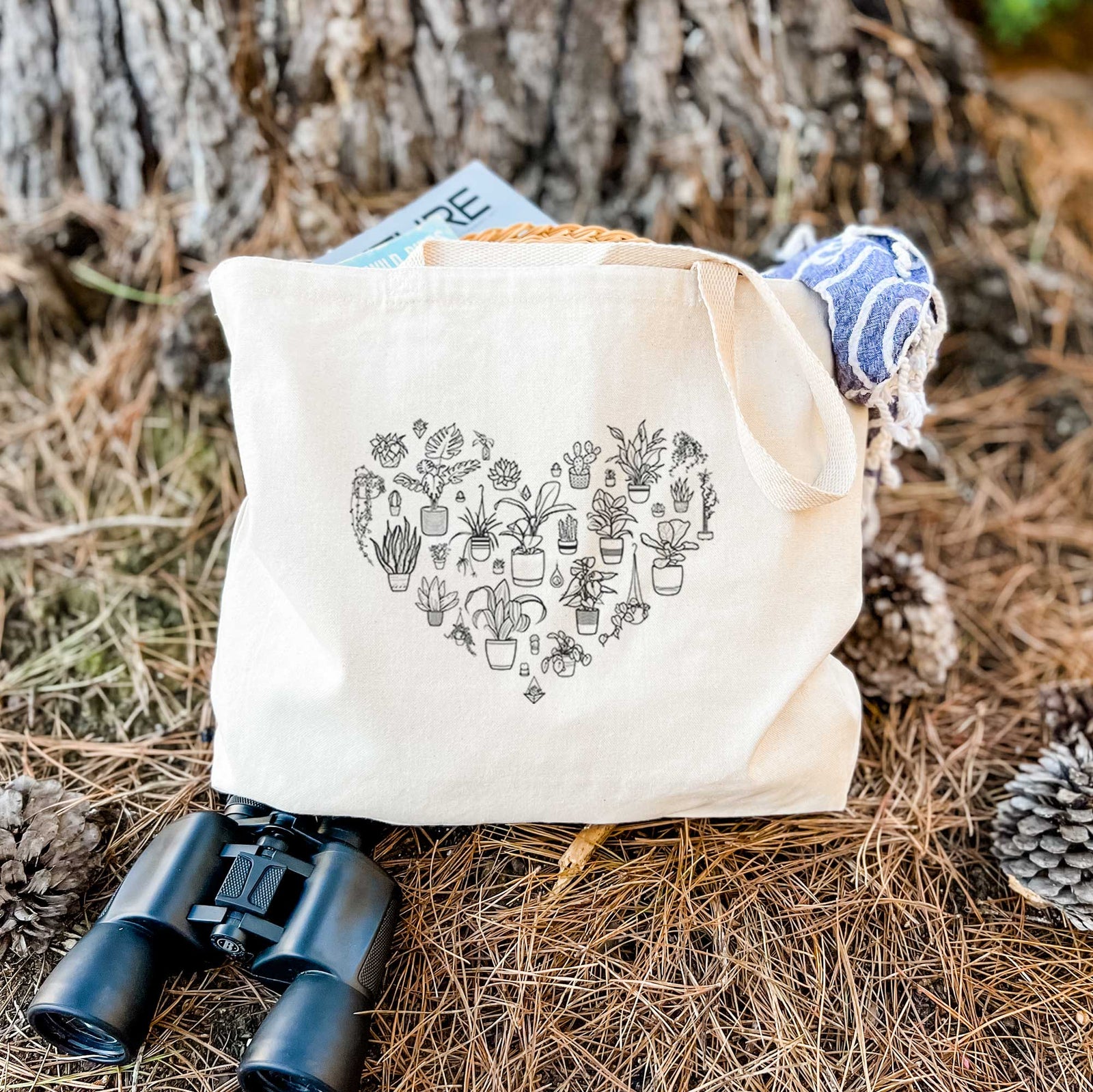 Natural canvas tote bag printed with a heart shape filled with black ink potted houseplants.