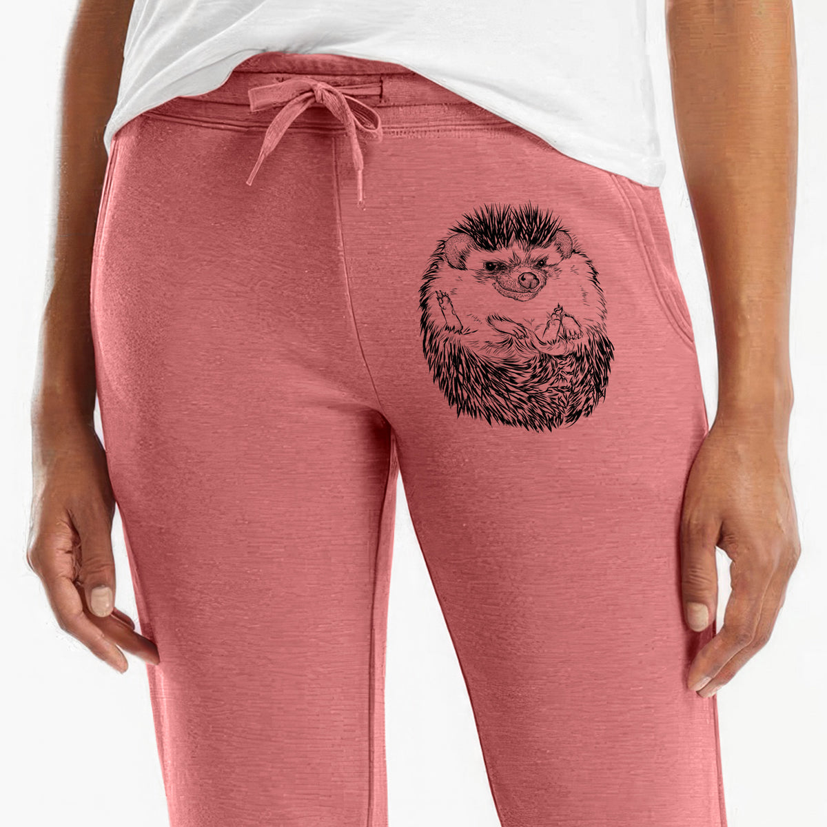 Front of dusty rose Cali Wave sweatpants, printed with a detailed black ink illustration of a hedgehog curled up and facing forward on the leg.