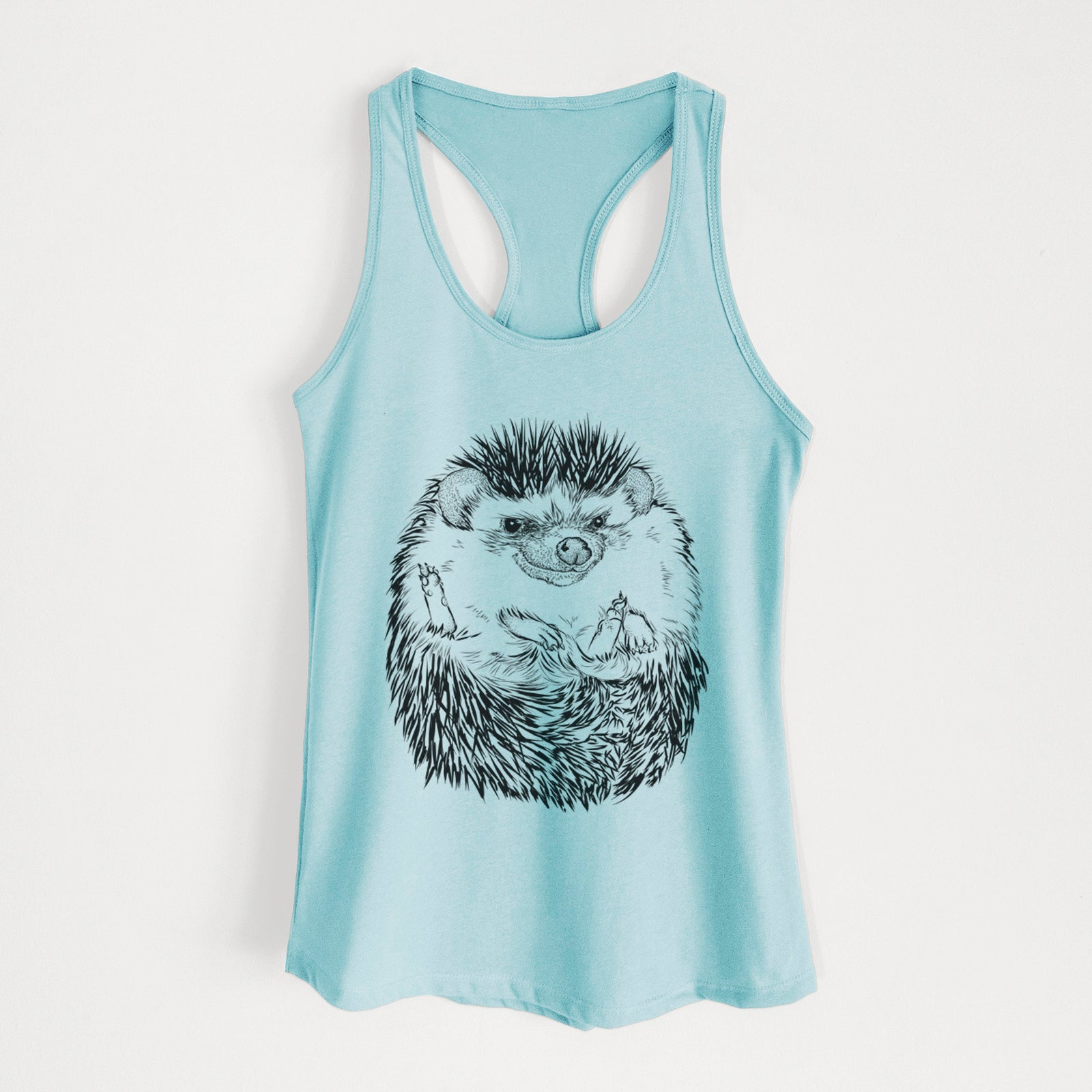 Banana cream women's racerback tank top laid flat, printed with a detailed black ink illustration of a hedgehog curled up and facing forward.