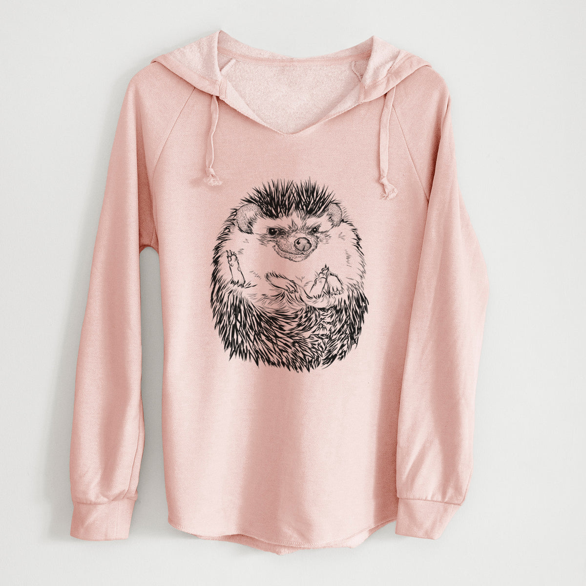 Blush pink women's Cali Wave hooded sweatshirt laid flat, printed with a detailed black ink illustration of a hedgehog curled up and facing forward.