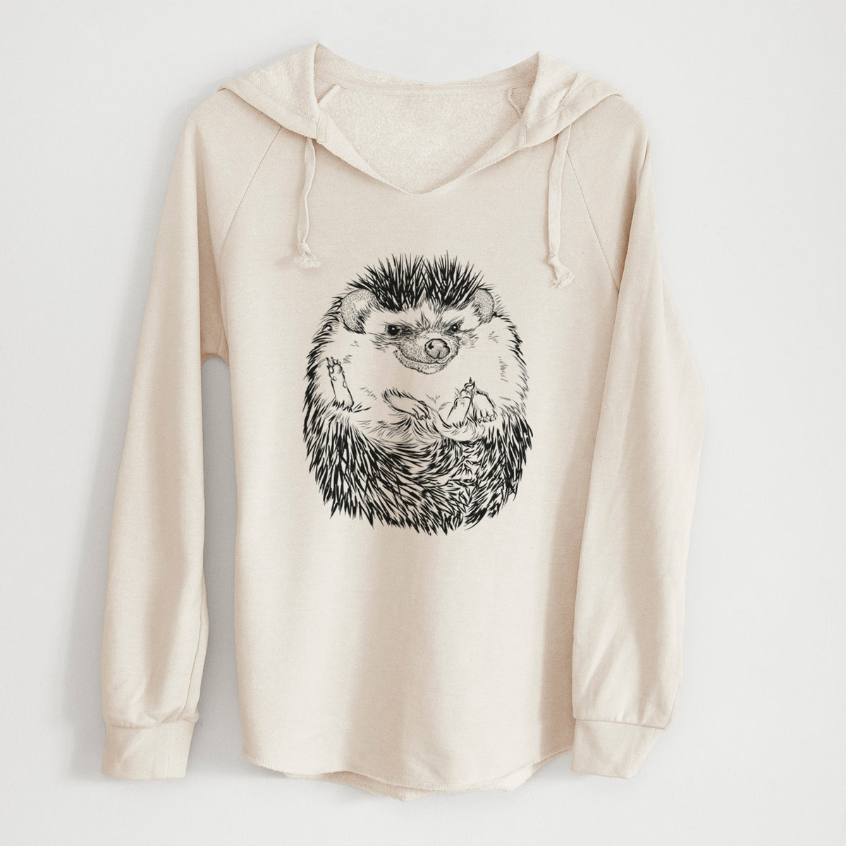 Bone cream women's Cali Wave hooded sweatshirt laid flat, printed with a detailed black ink illustration of a hedgehog curled up and facing forward.