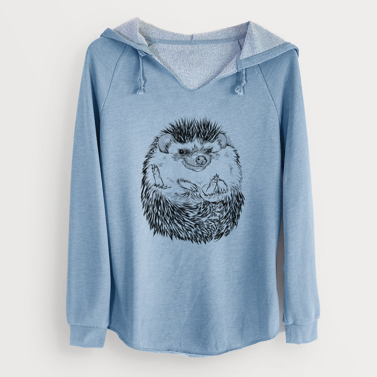 Misty blue women's Cali Wave hooded sweatshirt laid flat, printed with a detailed black ink illustration of a hedgehog curled up and facing forward.